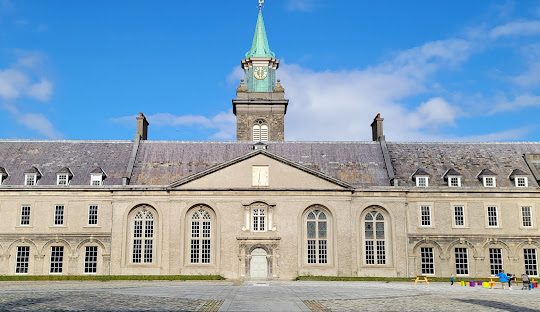 Low image of the full, grand building of museum with blue sky