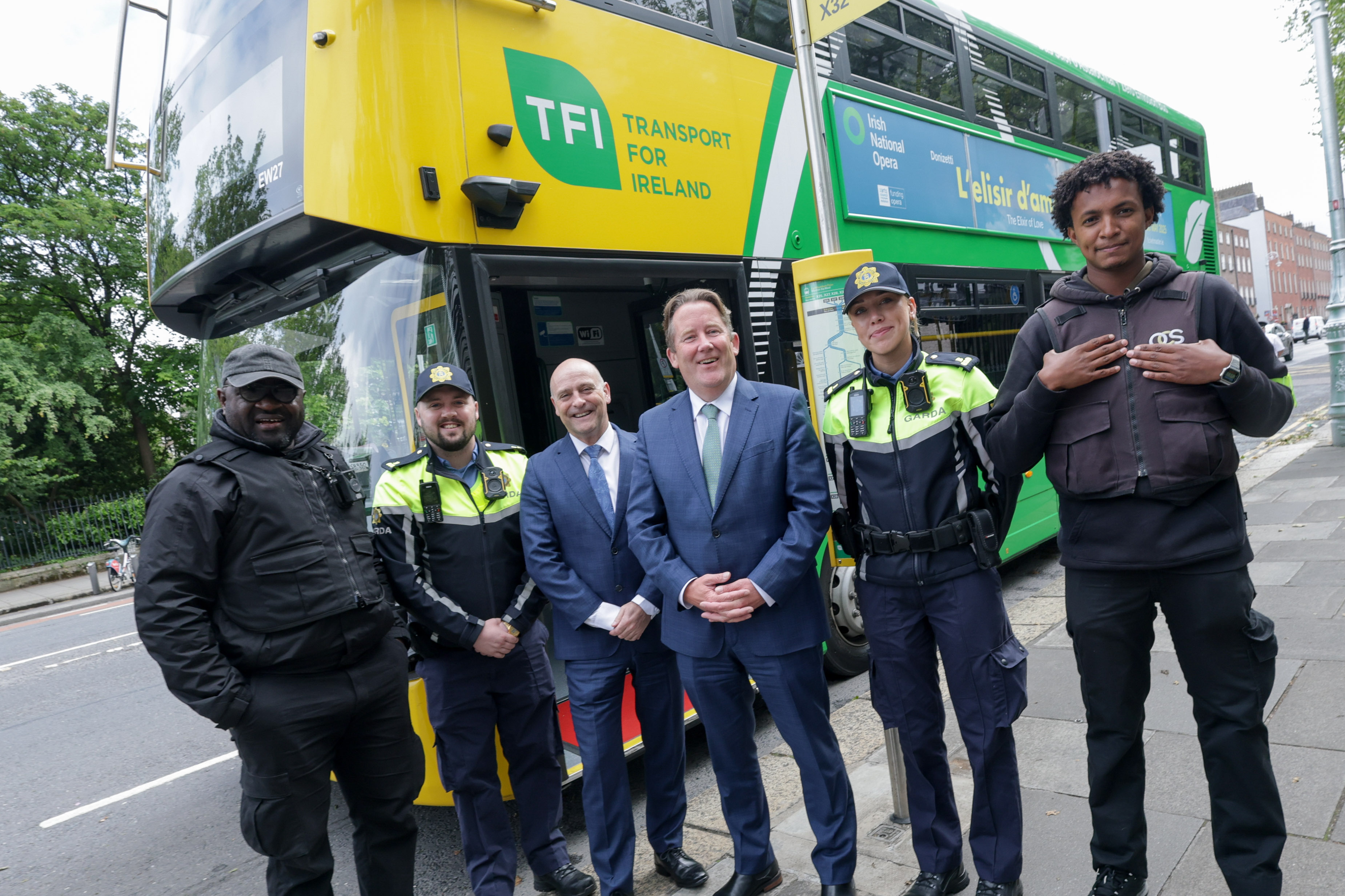 2 security guards from the safer journeys team, 2 gards and Billy Hann and the minister of transport in front of a Dublin Bus