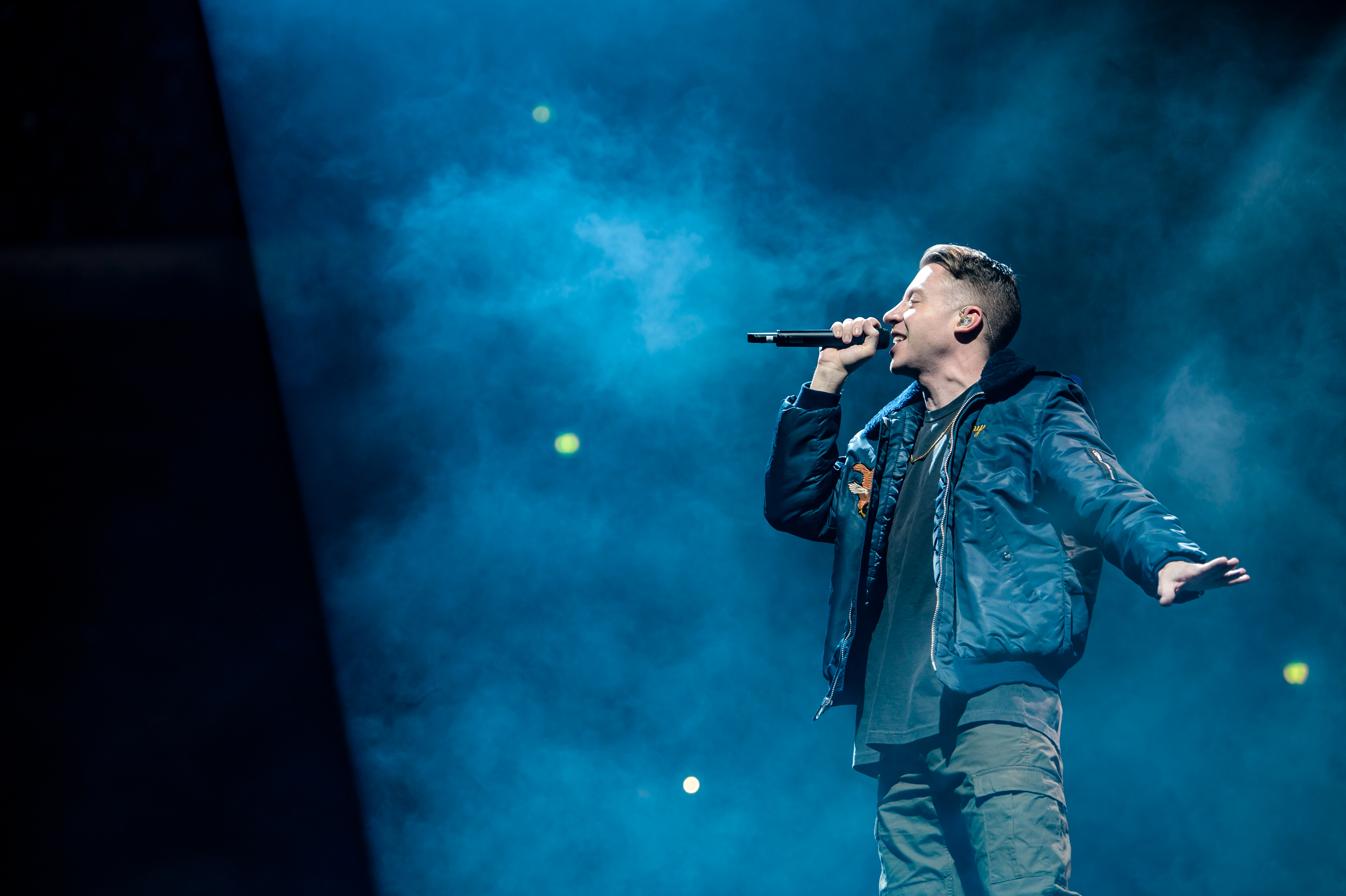 Image of Macklemore on stage with a microphone