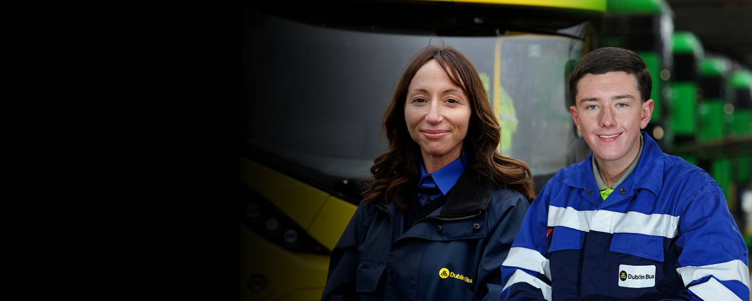 Female bus driver and male Mechanic in front of bus