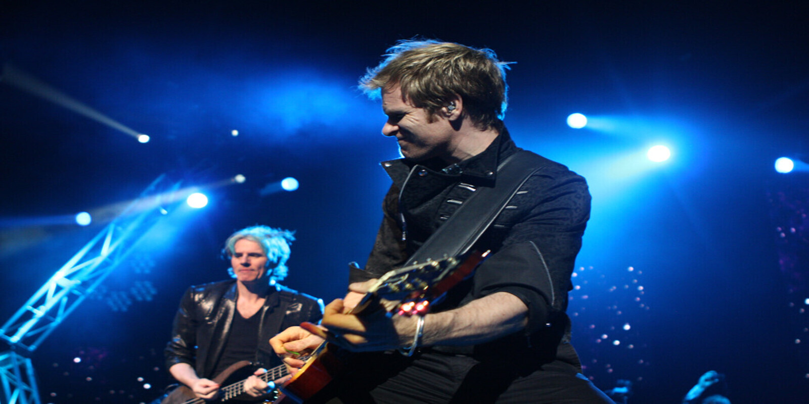Image of members of the Duran Duran band, both playing guitar